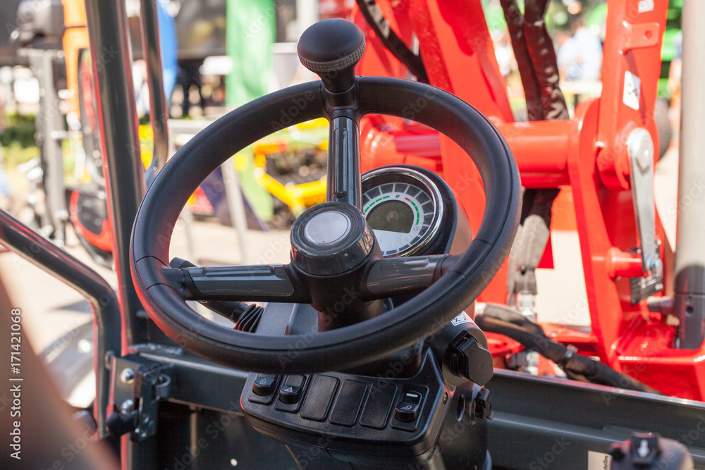 Close up of modern tractor steering wheel Close up of modern tractor steering wheel