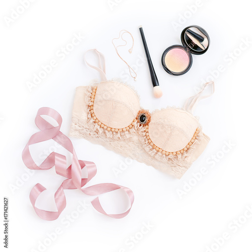 Glamorous stylish sexy lace lingerie with woman accessories on white background. Woman lace bra with perfume and make up items, flat lay, top view. Shopping and fashion concept, textile, underwear.