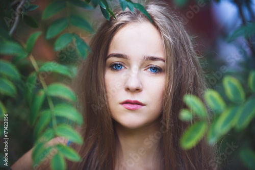 Close-up portrait of the young girl in a forest