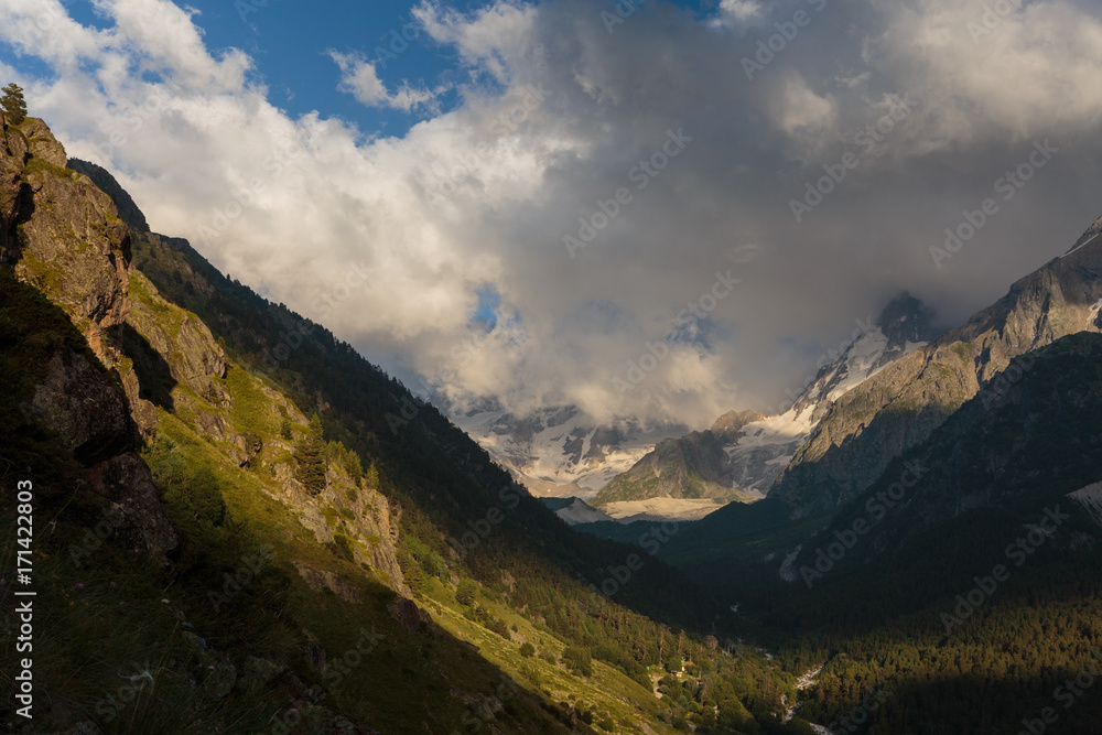 Fototapeta premium Russia, Republic of Kabardino-Balkaria, time lapse. Summer in the mountains of the Caucasus. Formation and movement of clouds over mountains peaks.
