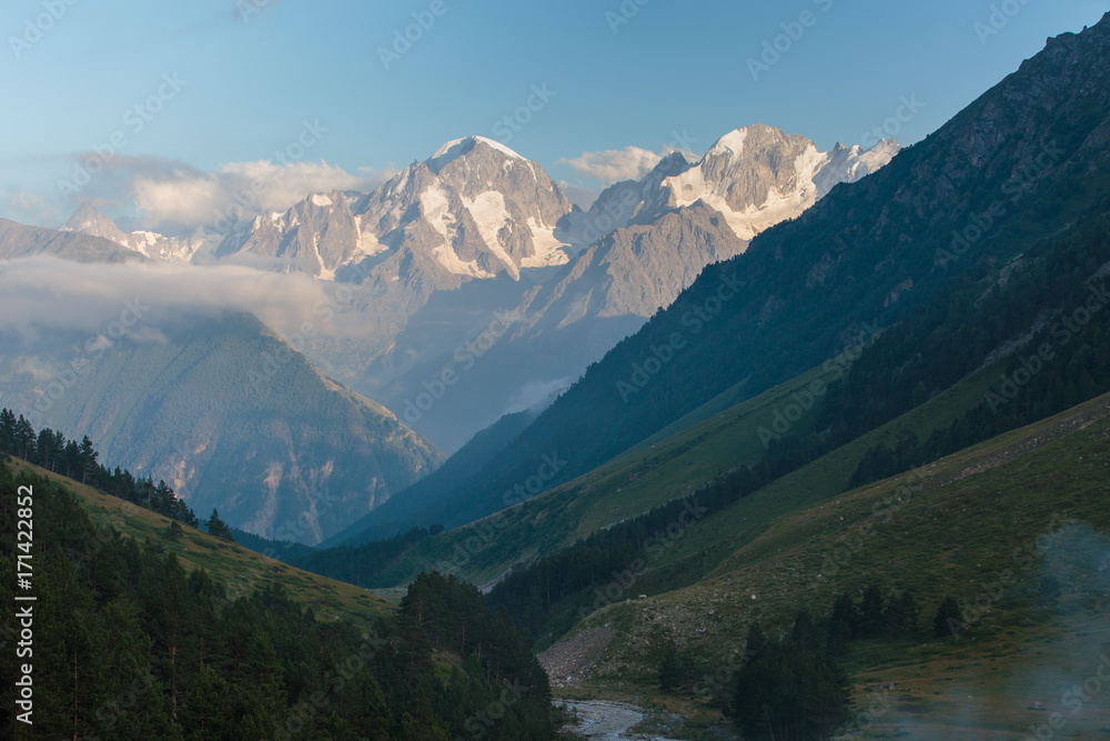 Obraz premium Russia, Republic of Kabardino-Balkaria, time lapse. Summer in the mountains of the Caucasus. Formation and movement of clouds over mountains peaks.