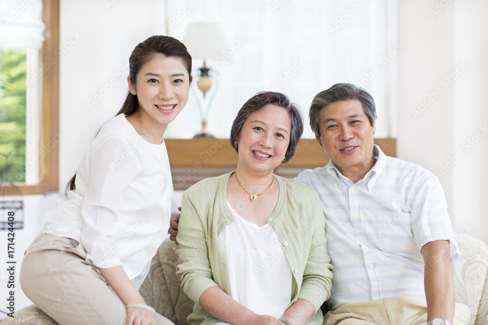 Senior couple and daughter sitting side by side Senior couple and daughter sitting side by side