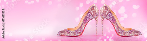 High heels shoes banner on blurred pink background