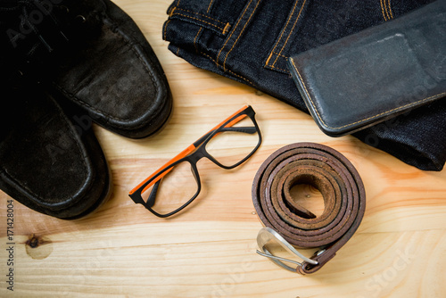 man casual outfits fashion accessories wooden table, (shirt,jean,wallet,sunglasses,glasses,Belt,shoes)