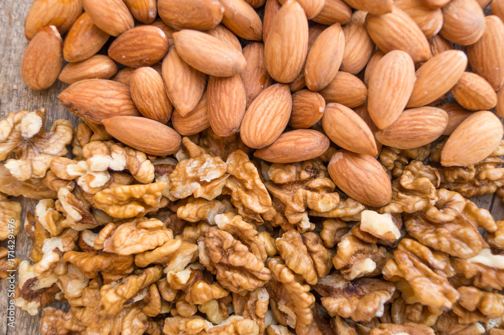 Walnuts and almonds are located horizontally, background, texture Walnuts and almonds are located horizontally, background, texture