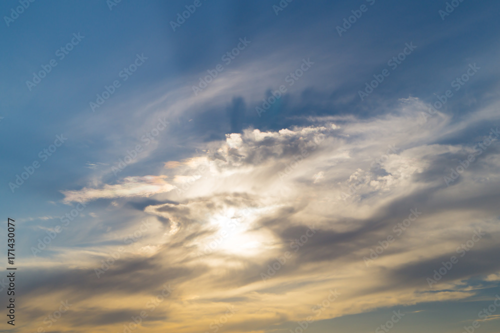 Grey and white clouds with the sun on the blue sky Grey and white clouds with the sun on the blue sky