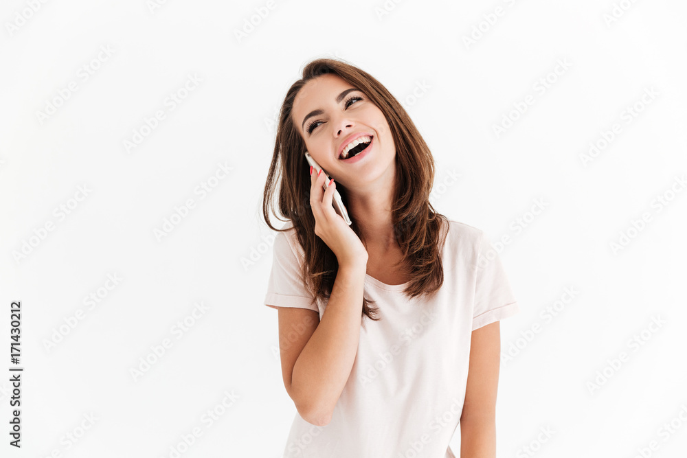 Laughing brunette woman talking by smartphone Laughing brunette woman talking by smartphone