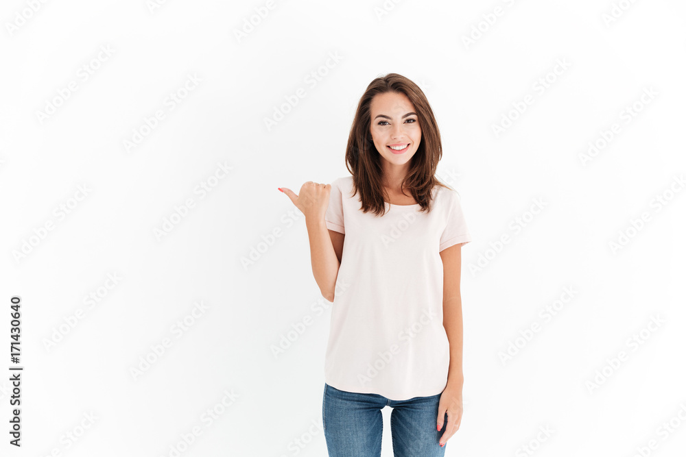 Beauty smiling brunette woman pointing away and looking at camera