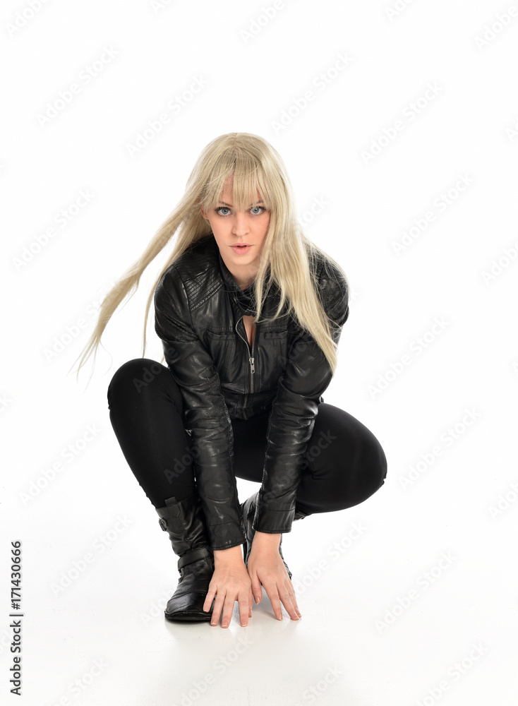 full length portrait of a blonde girl wearing black leather pose, crouching pose on white background. full length portrait of a blonde girl wearing black leather pose, crouching pose on white background.