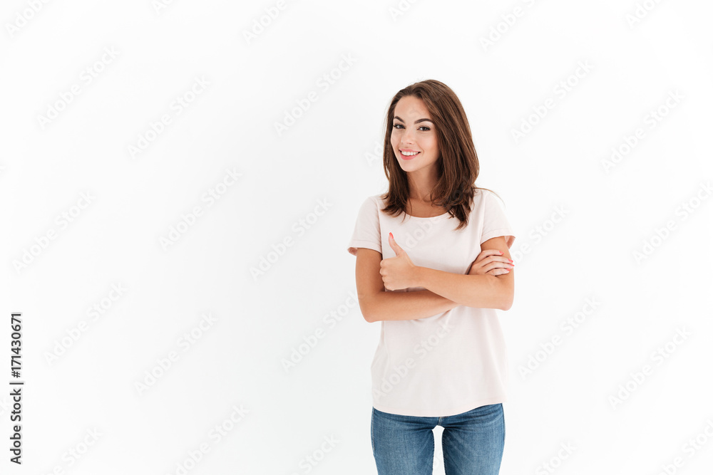 Smiling Attractive woman with crossed arms showing thumb up Smiling Attractive woman with crossed arms showing thumb up