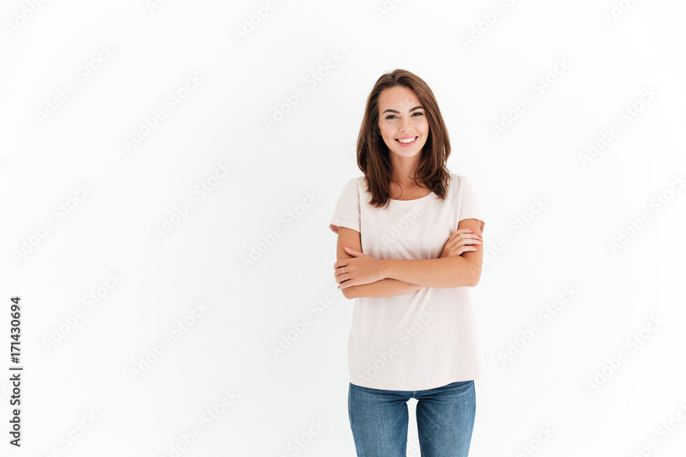 Smiling brunette woman with crossed arms looking at the camera Smiling brunette woman with crossed arms looking at the camera