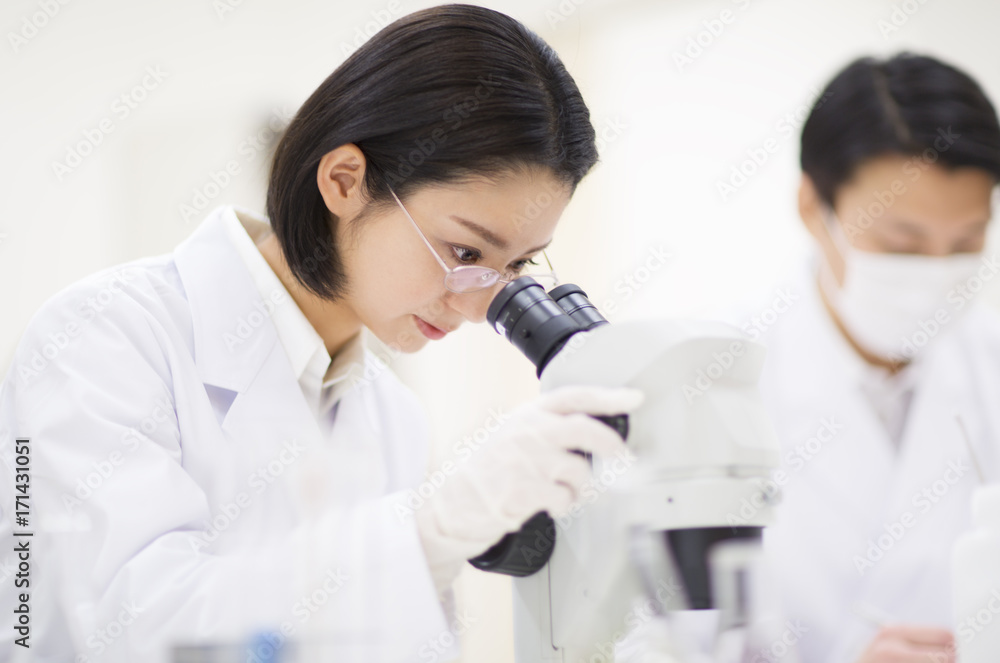 Female scientist using microscope Female scientist using microscope