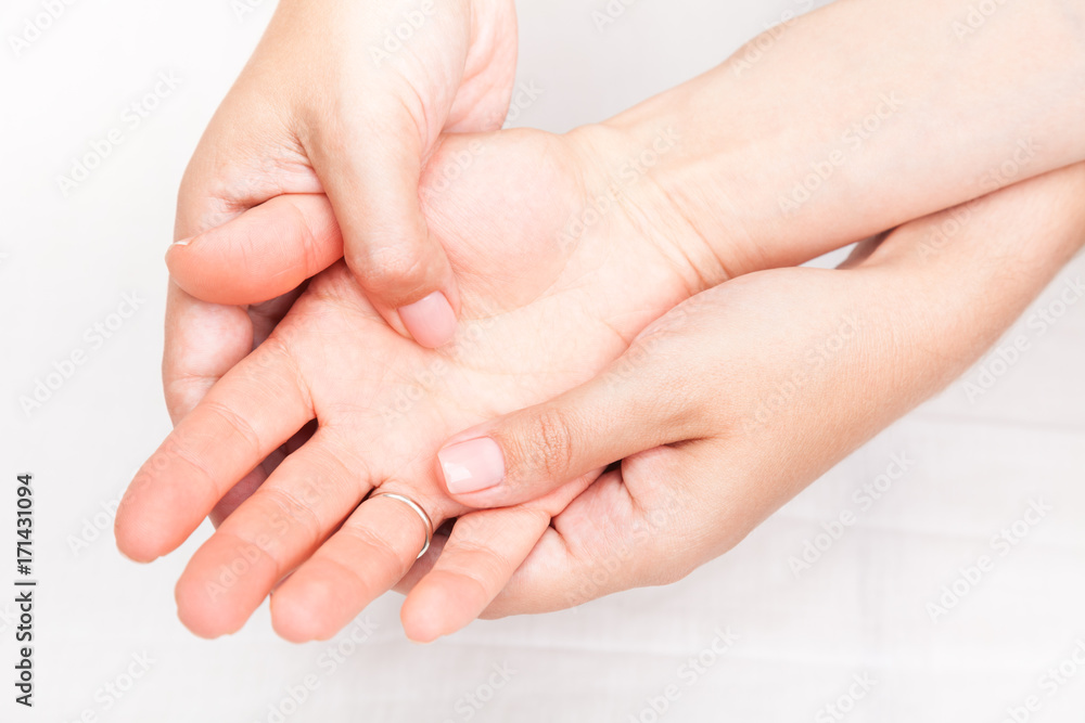 Woman receiving osteopathic treatment of her palm Woman receiving osteopathic treatment of her palm