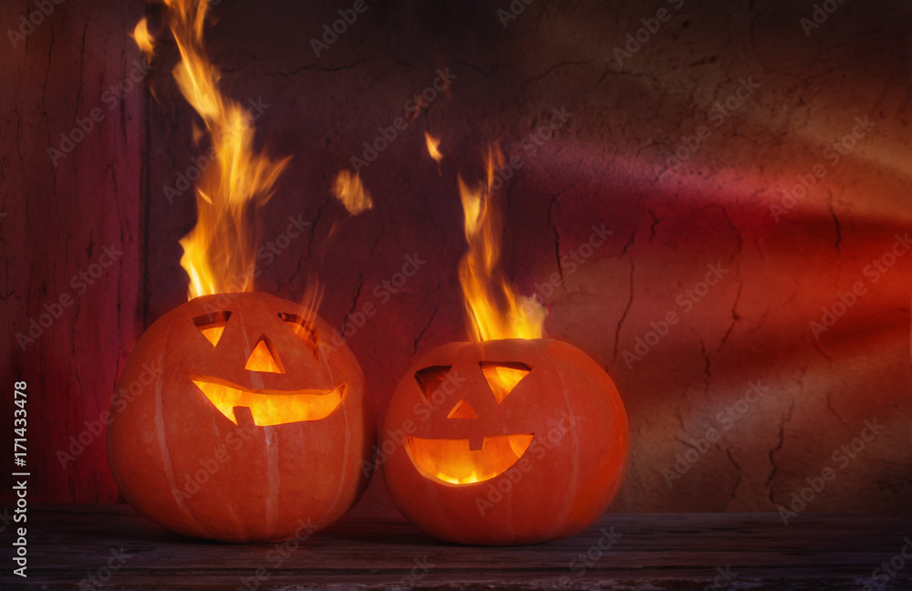Fototapeta premium Halloween pumpkins on wooden table on dark background