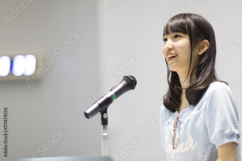 Female student talking at podium