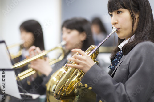Students practicing brass instruments in music room