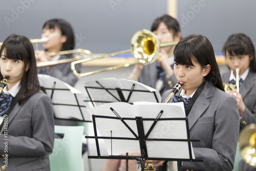 Students practicing brass instruments in music room