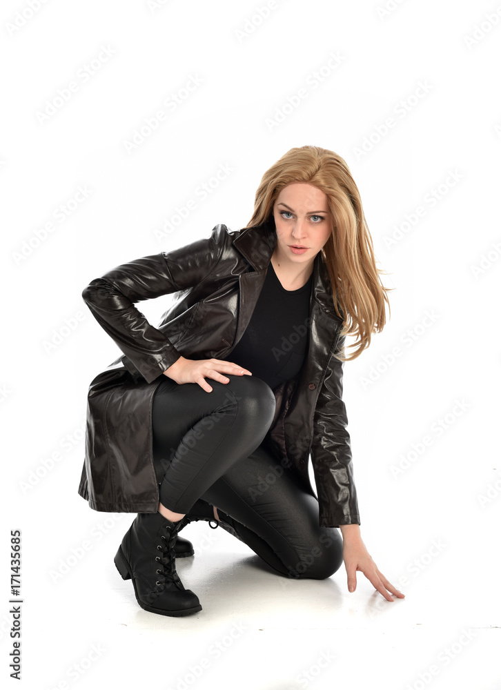 full length portrait of lady wearing leather coat and black clothing, isolated on white background. full length portrait of lady wearing leather coat and black clothing, isolated on white background.