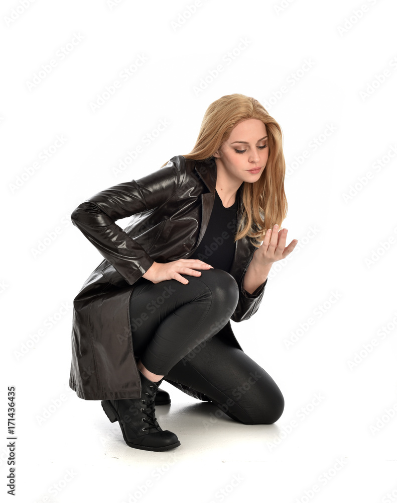 full length portrait of lady wearing leather coat and black clothing, isolated on white background. full length portrait of lady wearing leather coat and black clothing, isolated on white background.