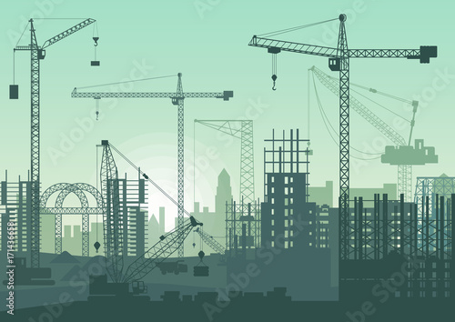 Tower cranes on construction site. Buildings under construction.