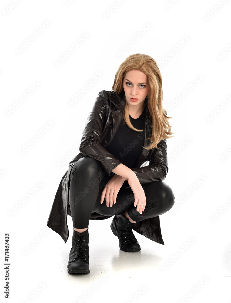 full length portrait of lady wearing leather coat and black clothing, isolated on white background. full length portrait of lady wearing leather coat and black clothing, isolated on white background.