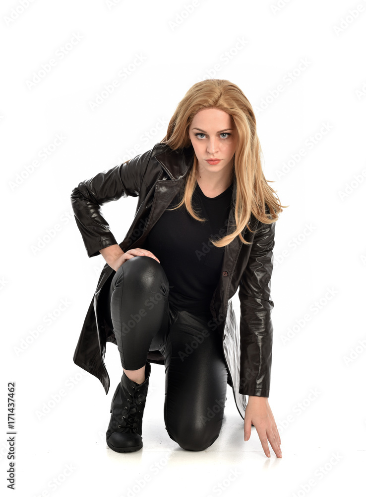full length portrait of lady wearing leather coat and black clothing, isolated on white background. full length portrait of lady wearing leather coat and black clothing, isolated on white background.