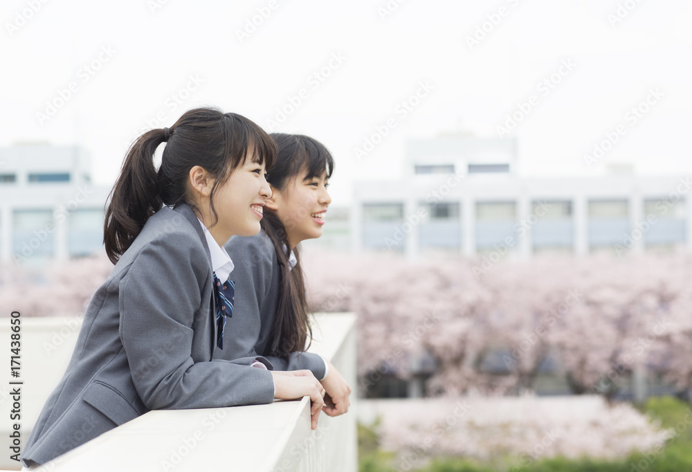 Two high school girls on rooftoplooking away Two high school girls on rooftoplooking away