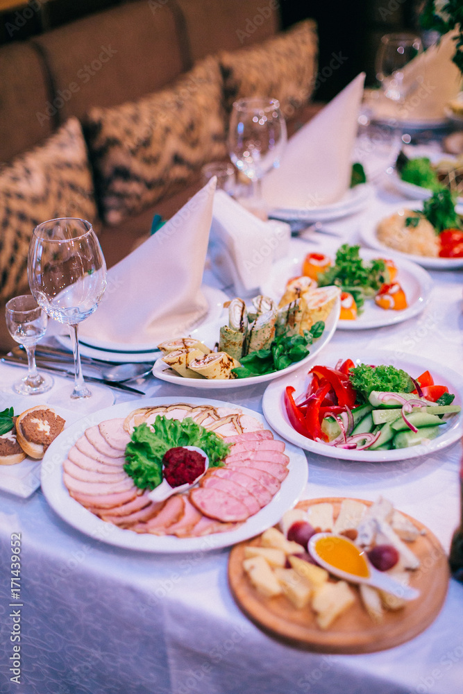 Beautifully decorated tables for guests with decorations and food. Beautifully decorated tables for guests with decorations and food.
