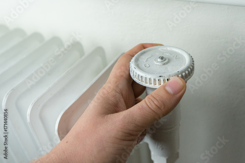 Central heating, white radiator with hand