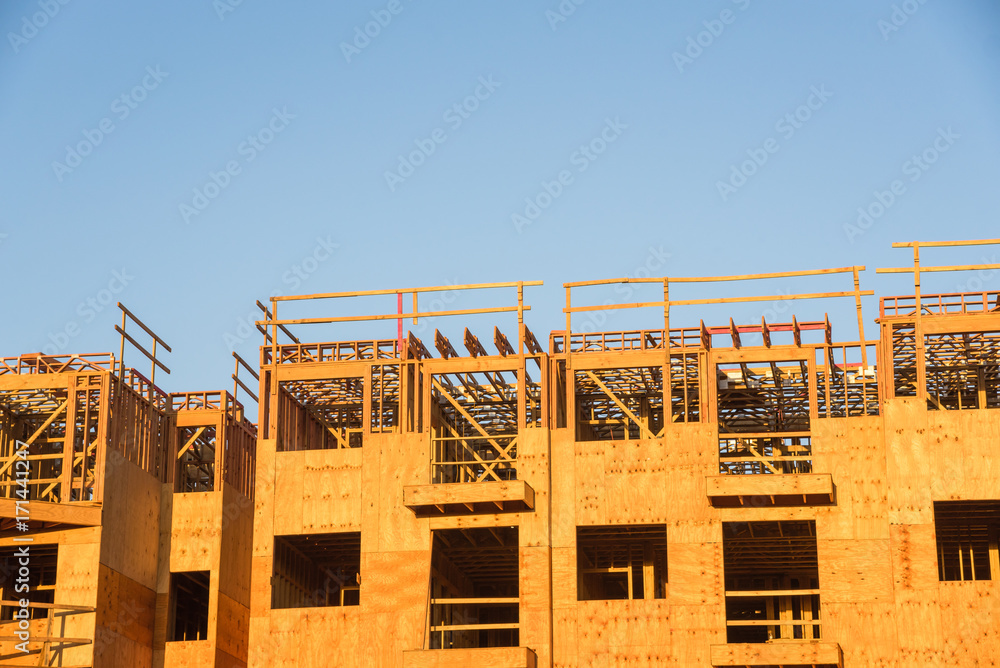 Close-up wood framing multi-storey apartment complex under construction ...