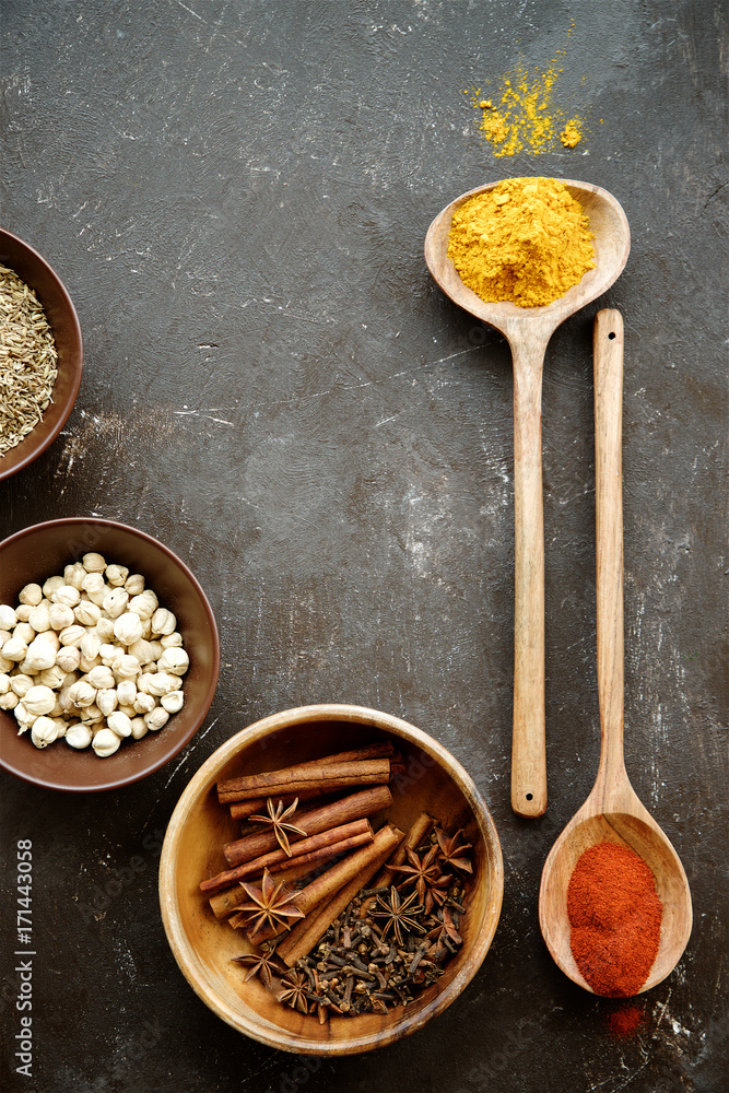 Variety of spices in bowls and spoons. Top view, empty space Variety of spices in bowls and spoons. Top view, empty space