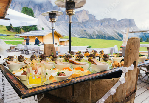 Bild auf Leinwand Aperitivo overlooking the Dolomites mountain range in South Tyrol, northern Ital