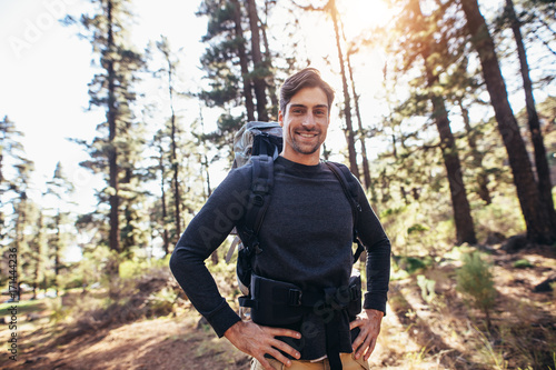 Man walking in forest wearing a backpack