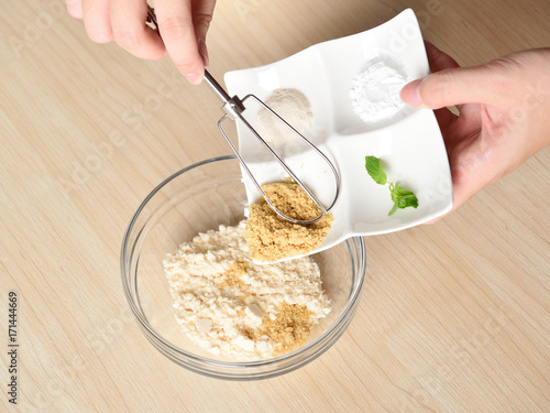 Принти на полотні baking powder in a bowl and coconut flour in a white plate mix together