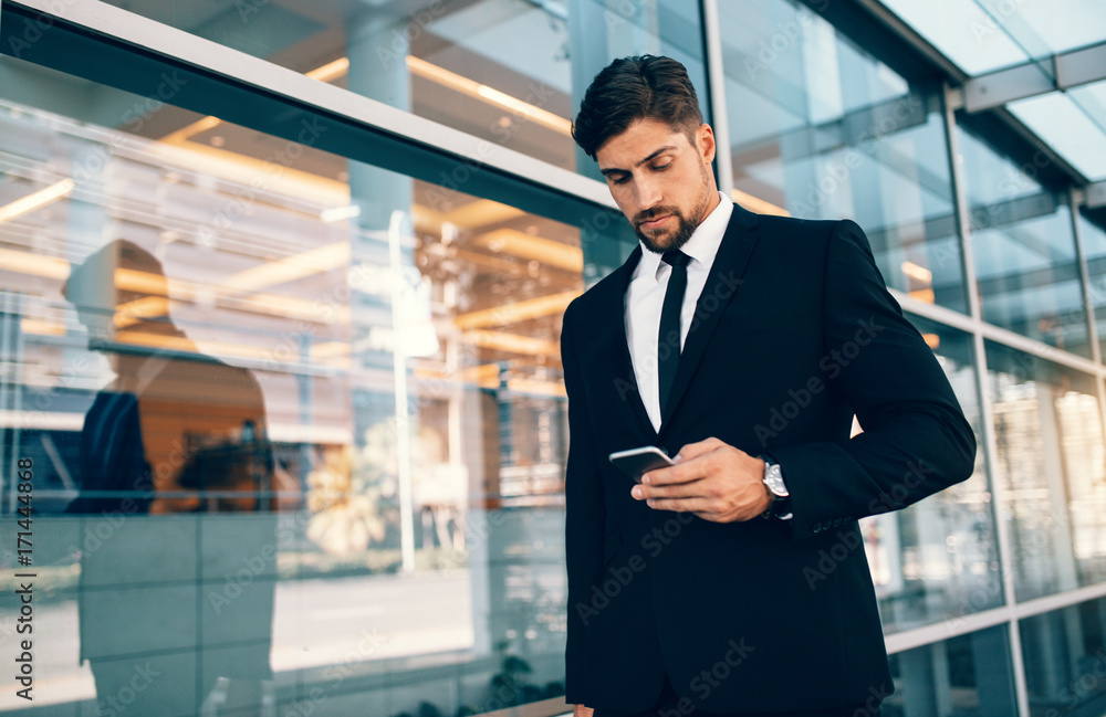 Businessman using mobile phone at airport Businessman using mobile phone at airport