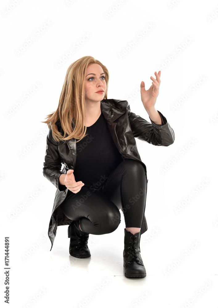 full length portrait of lady wearing leather coat and black clothing, isolated on white background. full length portrait of lady wearing leather coat and black clothing, isolated on white background.