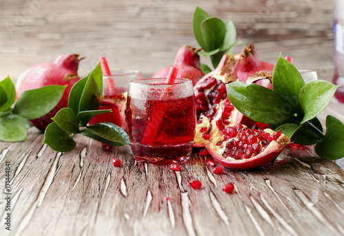 Fresh pomegranates and juice, selective focus