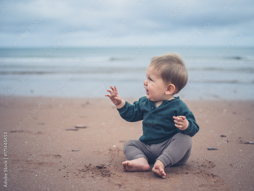Little baby sitting on the beach Little baby sitting on the beach