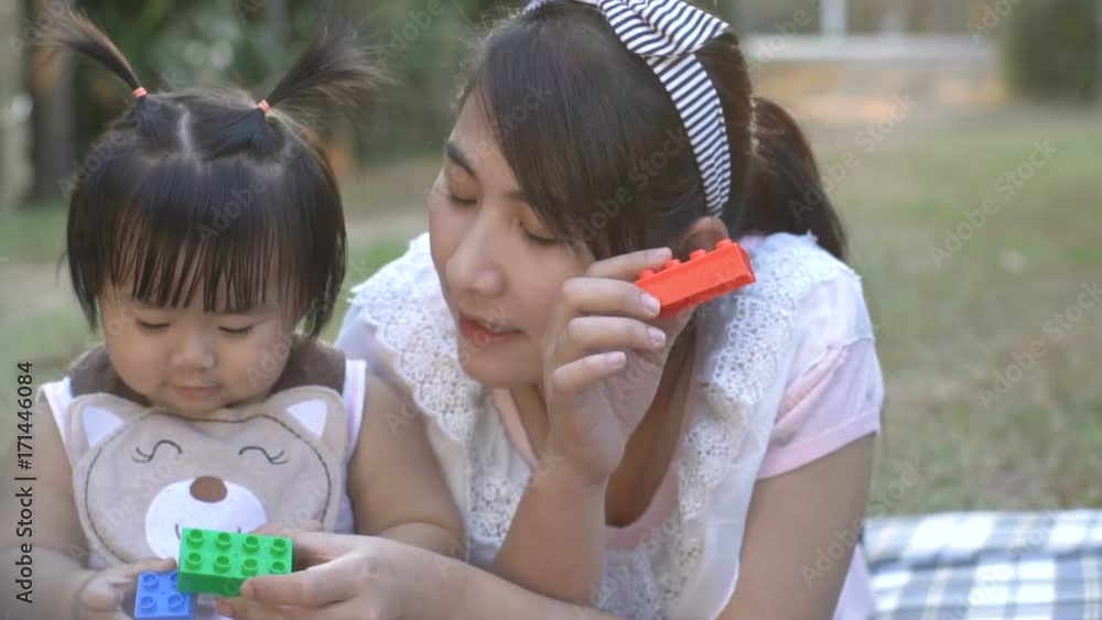 Asian baby girl playing blocks with her mom Asian baby girl playing blocks with her mom
