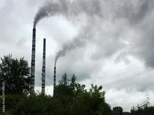 Pipes of thermal power plant are emitting smoke.