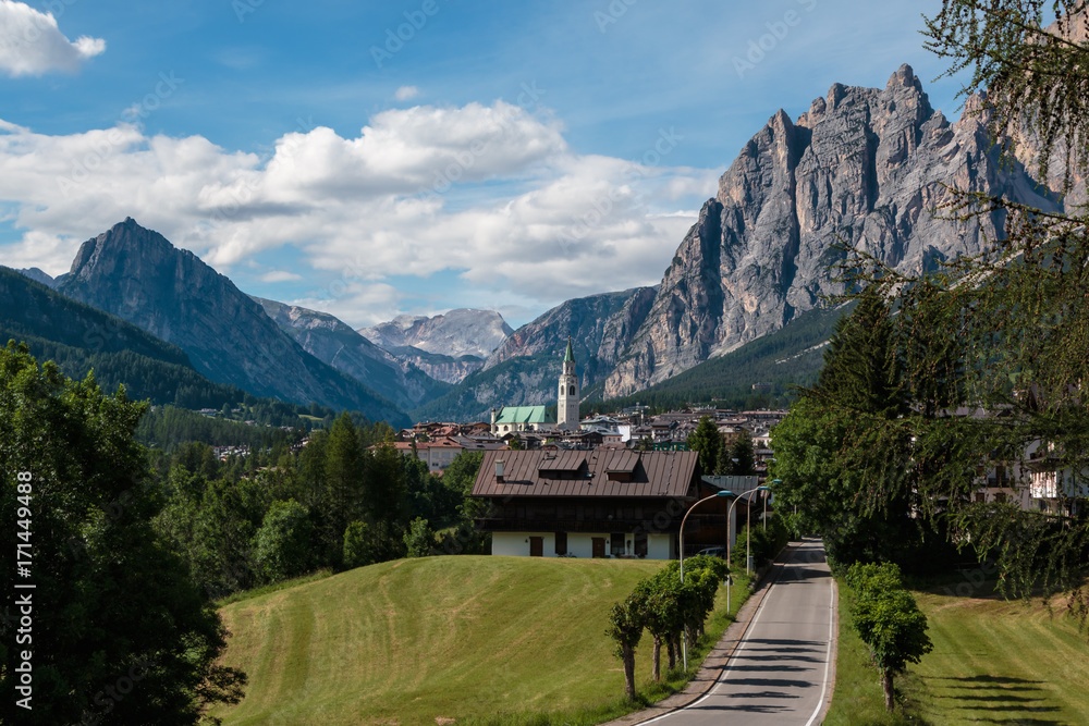 Green Meadow and Typical Houses among Mountains Scenery in Summer Time: Cortina D'Ampezzo