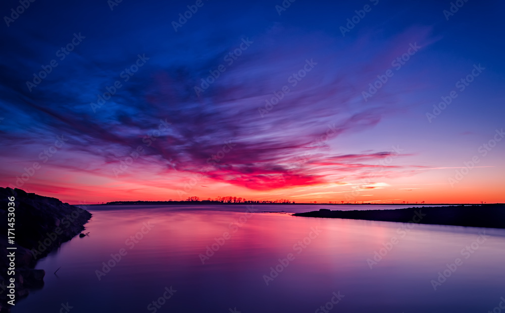 Long exposure sunset. Very red and blue sky.