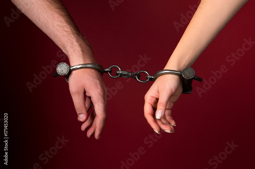 Bild auf Leinwand male and female hands are handcuffed.