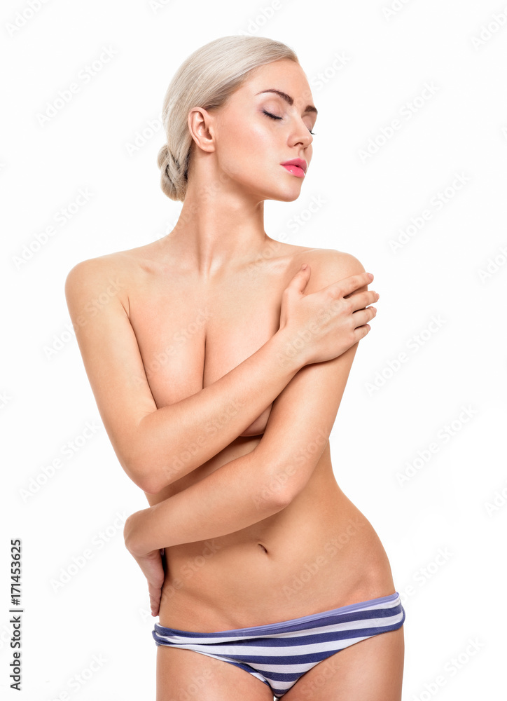 Obraz premium Beautiful young woman with clean skin nude topless breasts. Beautiful woman covering her nude breast.