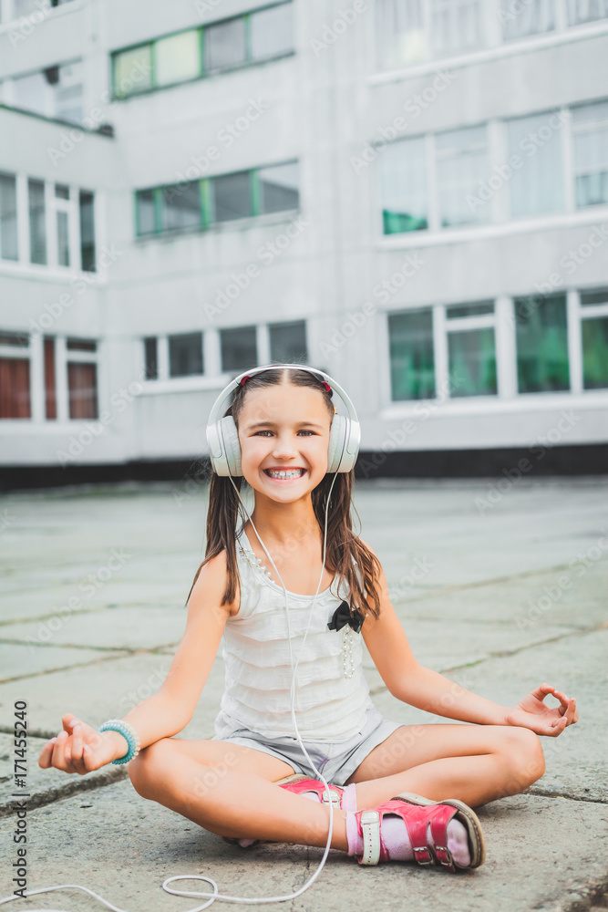 Fototapeta premium nice girl sitting and listening music with headphones