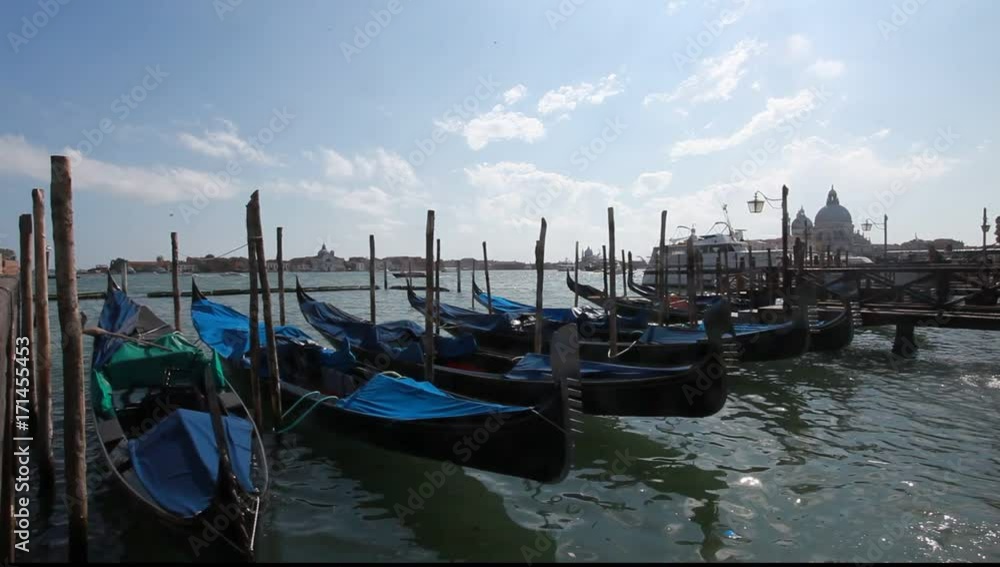 venice, italy. gondolas anchored in san marco square a venice, italy. gondolas anchored in san marco square a
