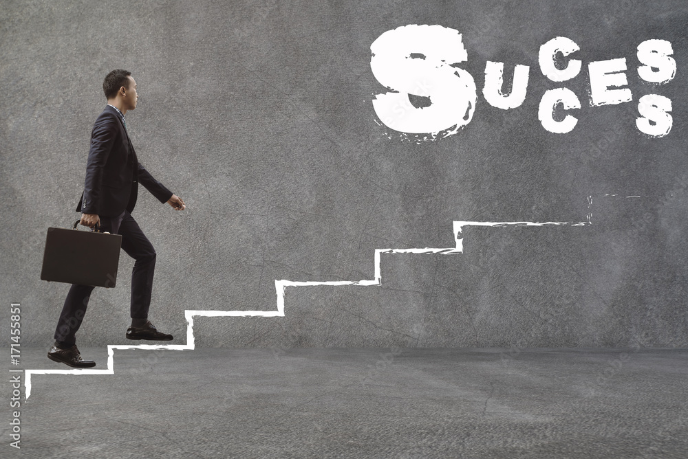 Asian Businessman walking up the stairs to find success.Conception of Business Success Asian Businessman walking up the stairs to find success.Conception of Business Success