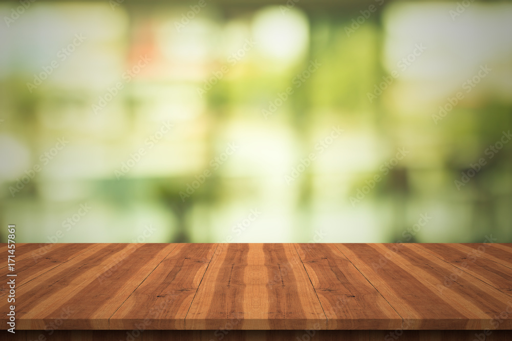 Empty teak wood table top on nature green blurred background,space for montage show products Empty teak wood table top on nature green blurred background,space for montage show products