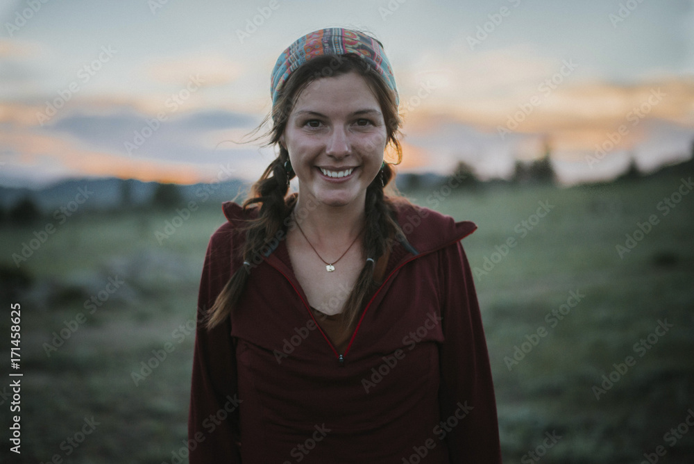 Portrait of happy woman standing at field during sunset Portrait of happy woman standing at field during sunset