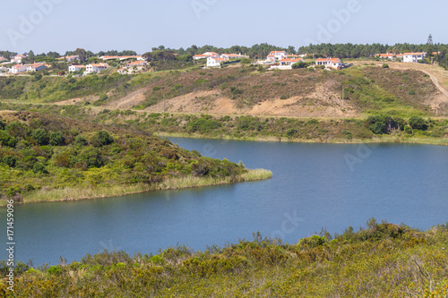 Houses, lake and trail in mountain in Arrifana